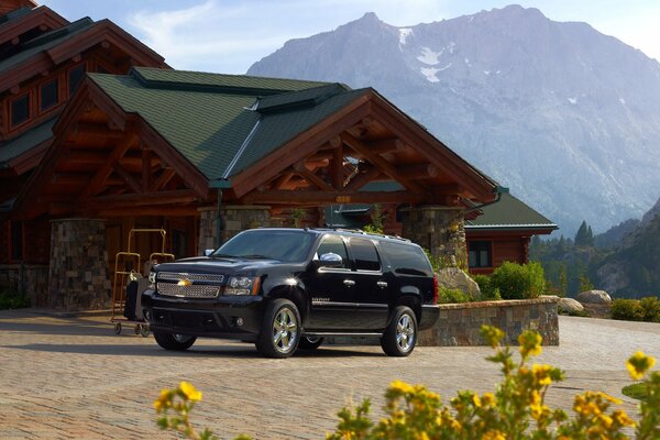 Black Chevrolet on the background of beautiful mountains