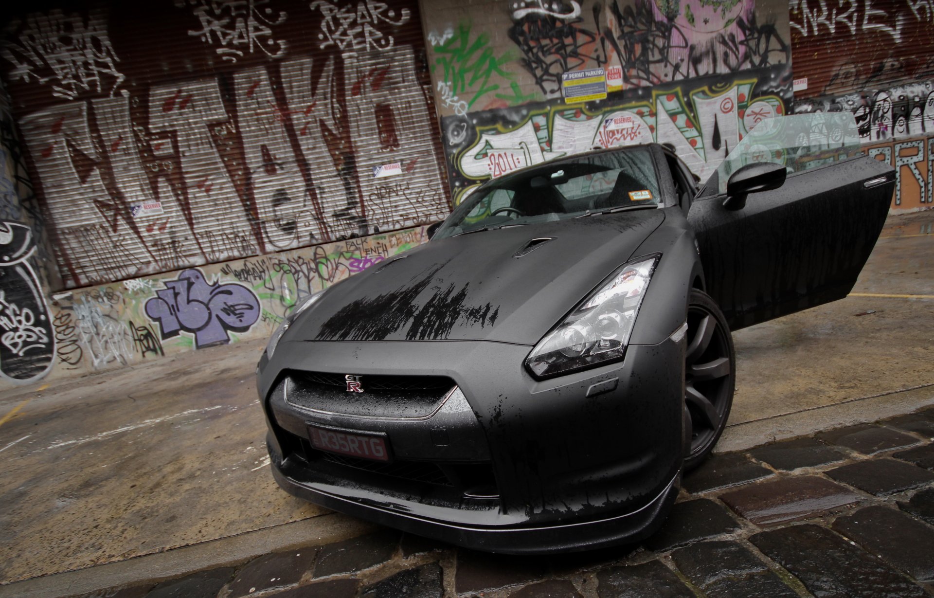 nissan gt-r black wet front graffiti