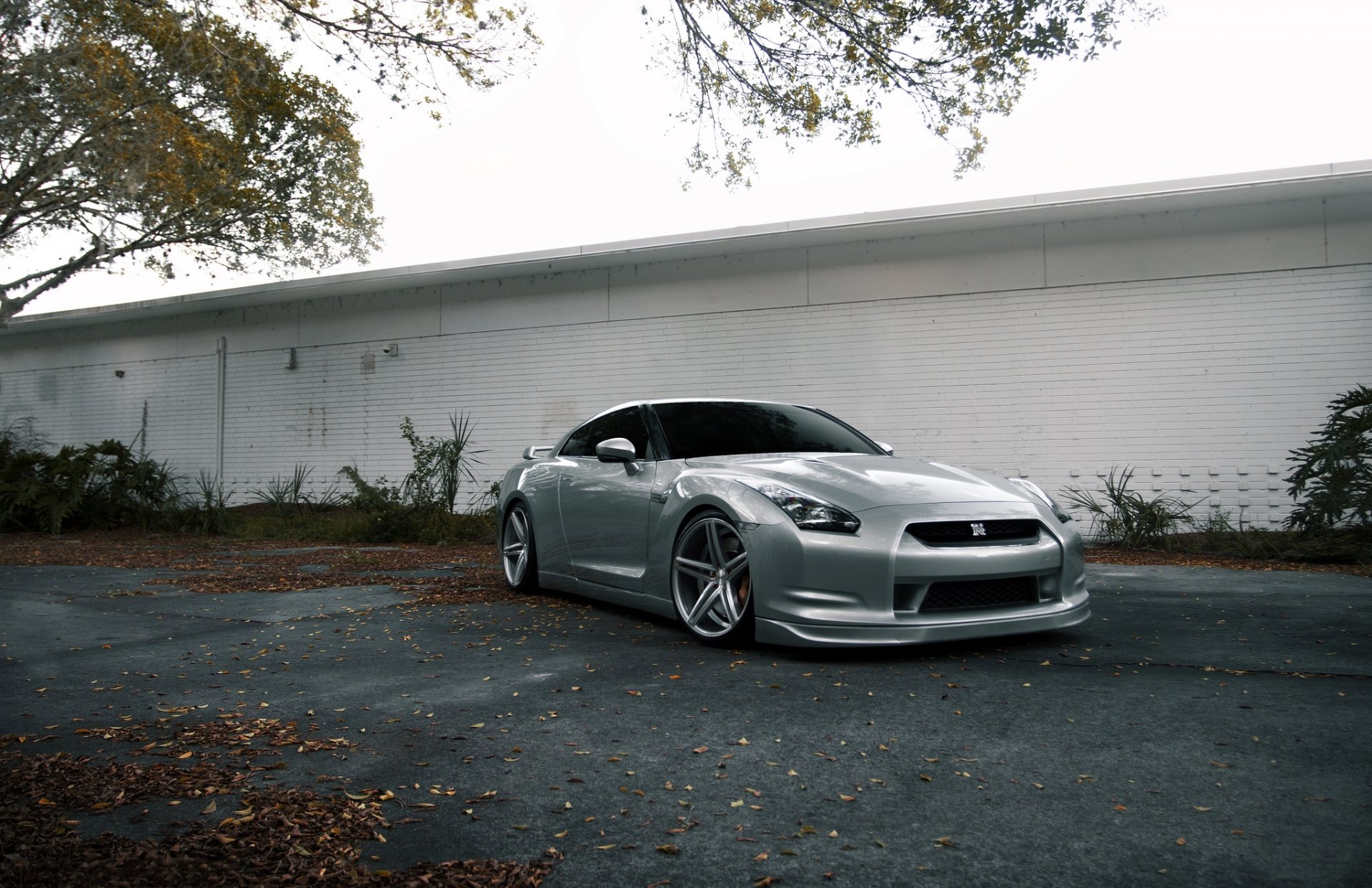 nissan gtr r35 silver nissan gtr silver front view building white asphalt leaf autumn