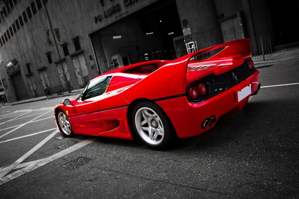 Red ferrari f50 on a city street