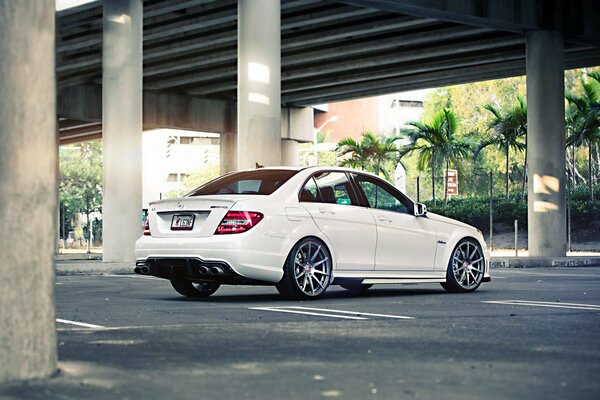 Mercedes-benz white car under the bridge