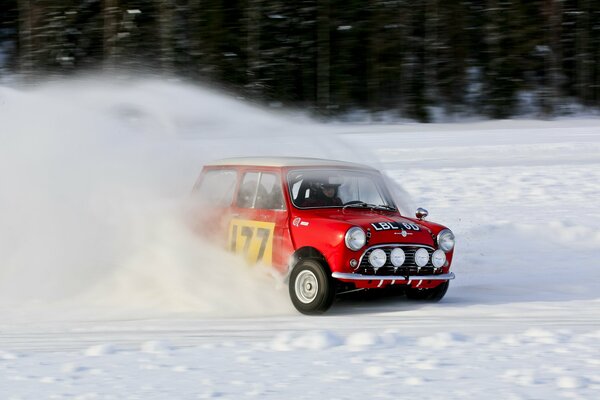 Red car at the moment of skidding in snowy weather