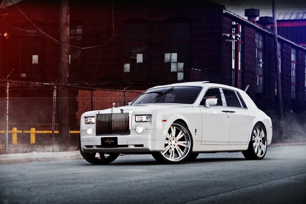 White and stylish Rolls Royce with a massive front