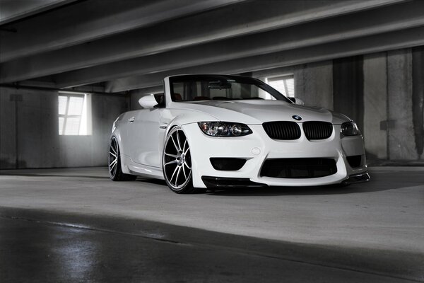 There is a white car on a black and white background