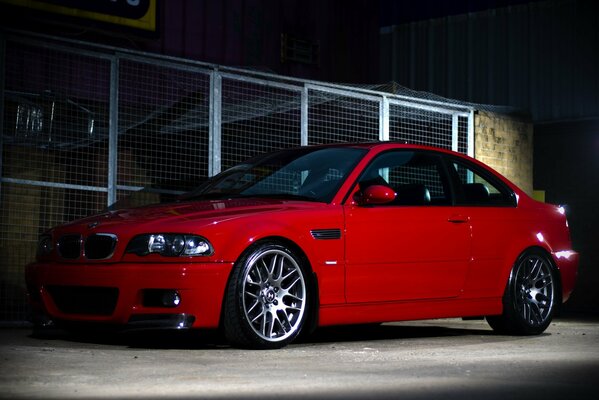 A bright red BMW is standing at the grille