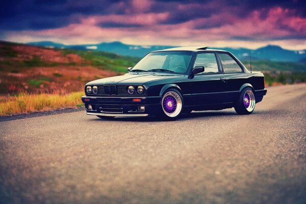 BMW e30 with tuning on an asphalt road in processing