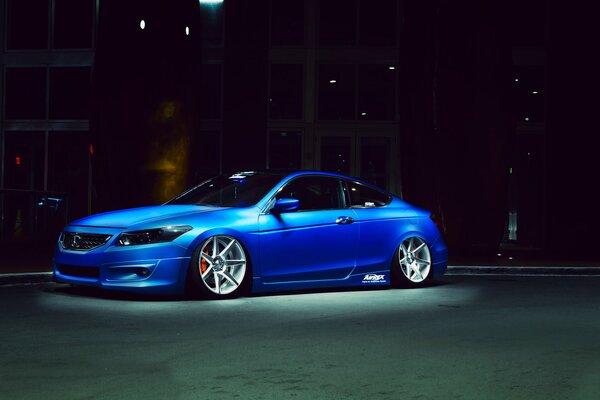 Blue honda accord at night under the spotlight