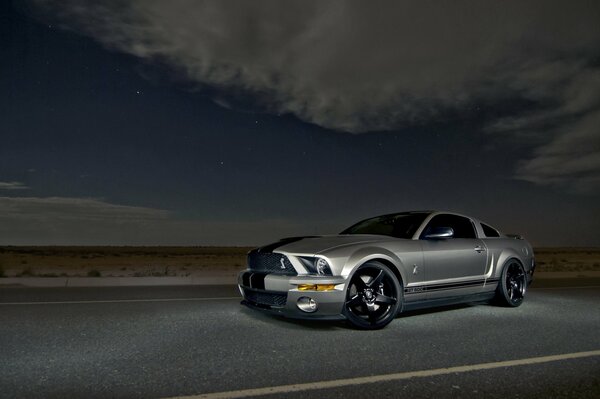 Silver muscle car on the night road