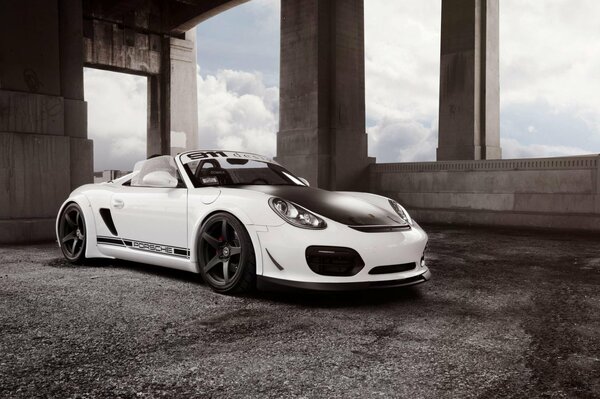 White Porshe boxster with black hood