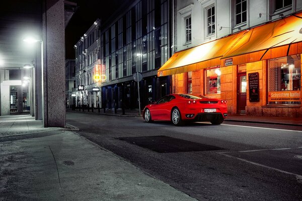 Red Ferrari at night windows