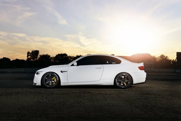 White BMW m3 e92 with black wheels on the side