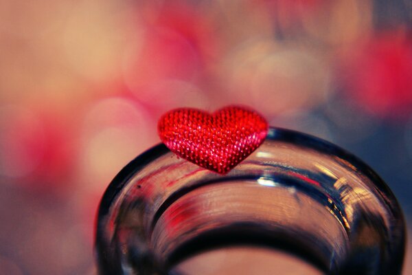 A red heart on the neck of a jar taken in close-up