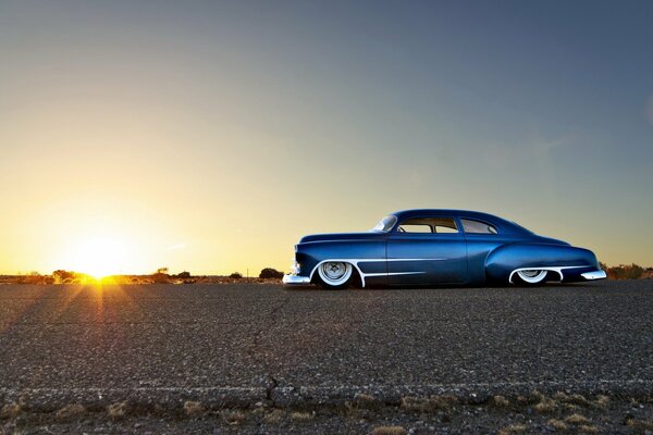 Classic blue Chevrolet at sunset