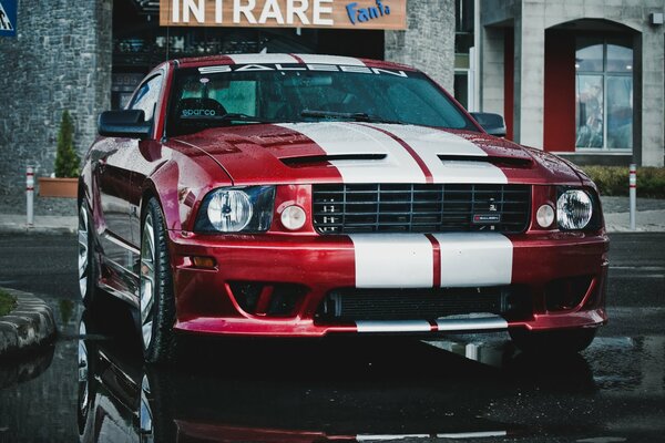 Red and white Ford Mustang in the rain