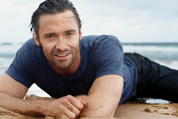 Hugh Jackman is relaxing on the beach by the sea