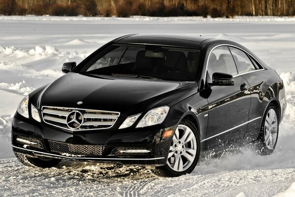 Black Mercedes drifting in the snow