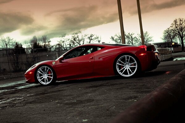 Red car on the background of a post-apocalyptic landscape