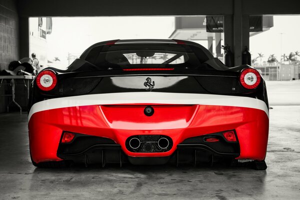 Red and black Ferrari. View from the rear