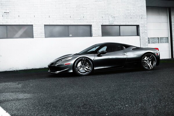 Ferrari negro contra un edificio blanco