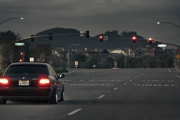 A black bmw car on an empty road