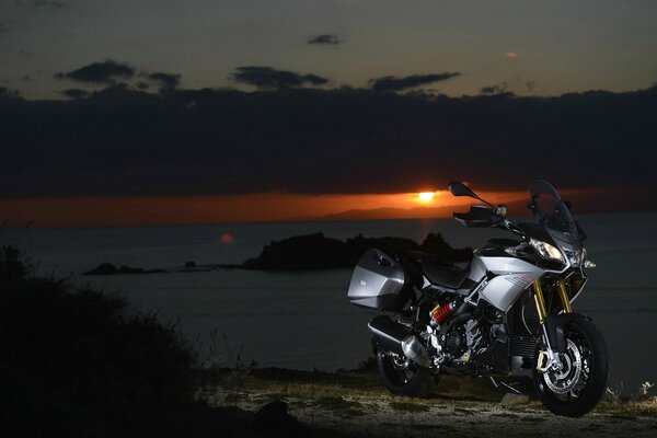 Motorrad, aprilia caponord 1200 im Hintergrund des Sonnenuntergangs