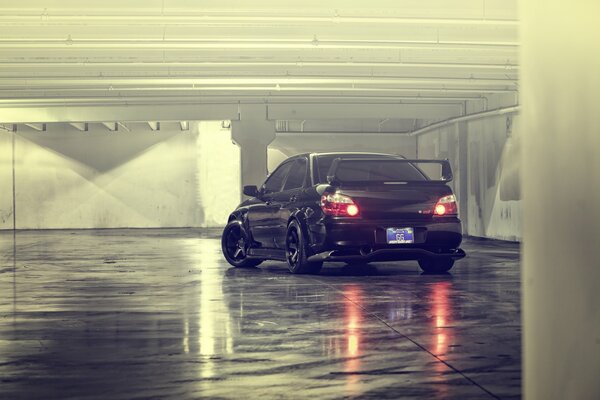 A tuned subaru impreza car in the parking lot