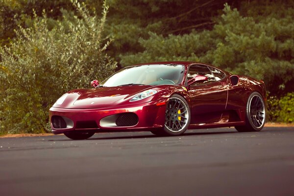 Beautiful tuning of a Ferrari on a background of trees