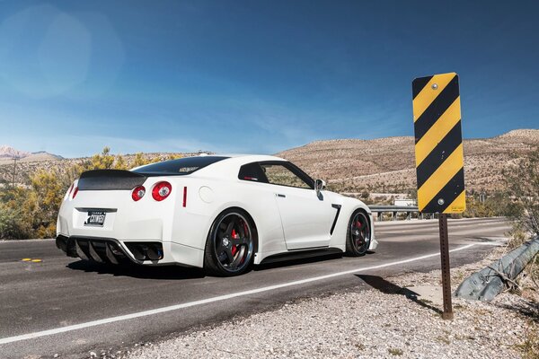 Nissan GTR bianca sulla strada in montagna