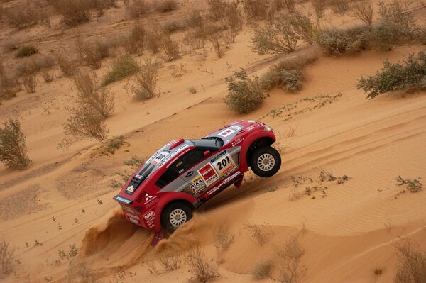 A red SUV. Rally on the sand