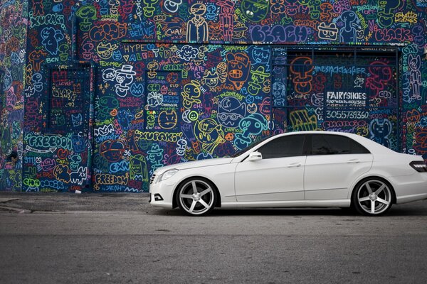 White, mercedes side on graffiti background