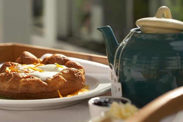 Süßes Brötchen und Tee zum Frühstück