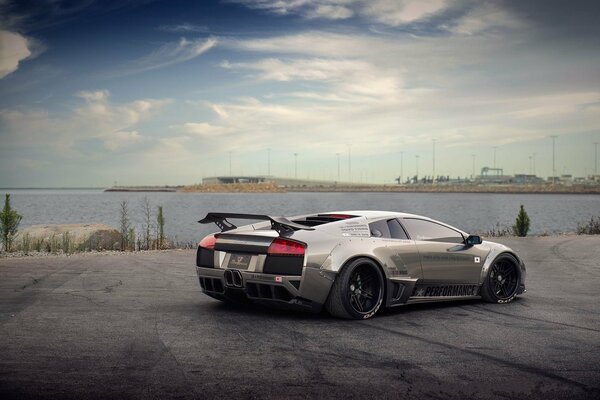 Grey Lamborghini Mursielago on the pier. Rear view