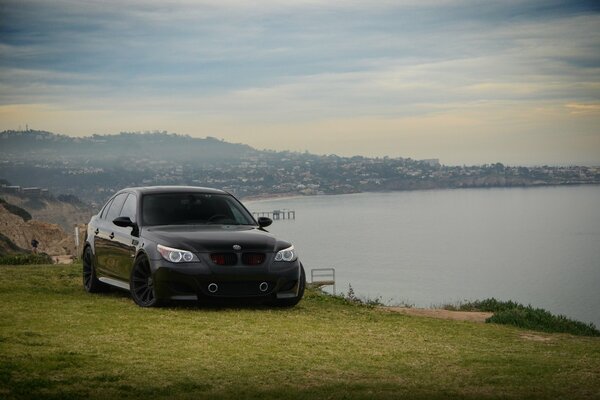 Black yuyuning BMW, on the seashore