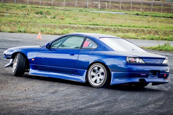 Blue Nissan sylvia drifts on the highway