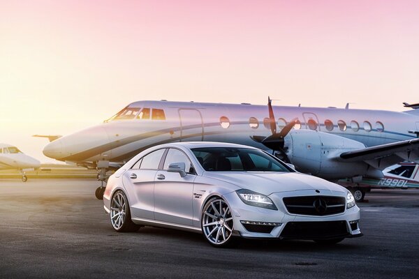 Tuned car near the plane