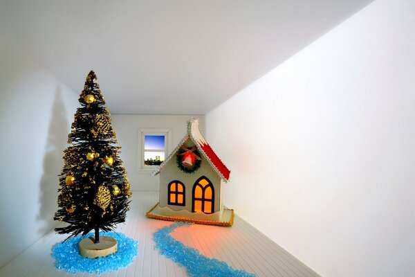 Una habitación vacía con un árbol de Navidad y una casa