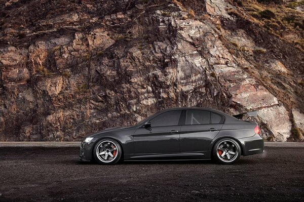 Black BMW on a rock background