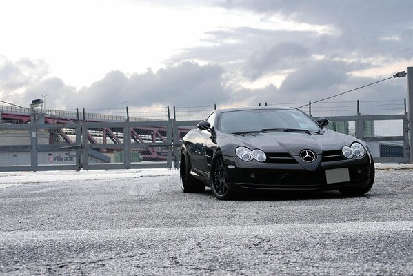 Black Mercedes Benz McLaren in cloudy weather