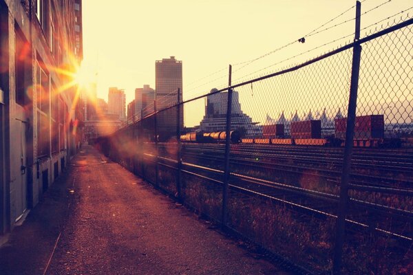 The sun rising over buildings and the railway