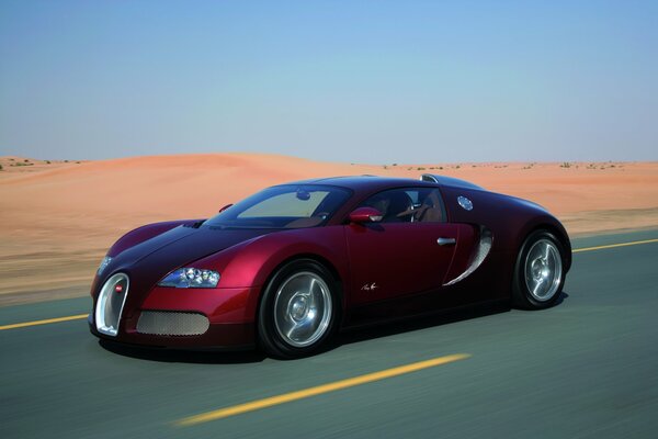 Red sports car in the middle of the desert