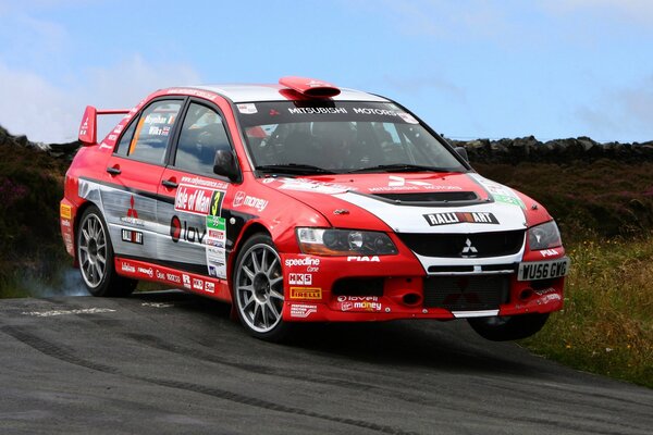 A red Mitsubishi sports car participates in the races