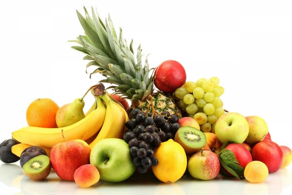 Fruit mix. Still life with pineapple, bananas, apples, kiwi, grapes, orange, pear and plums