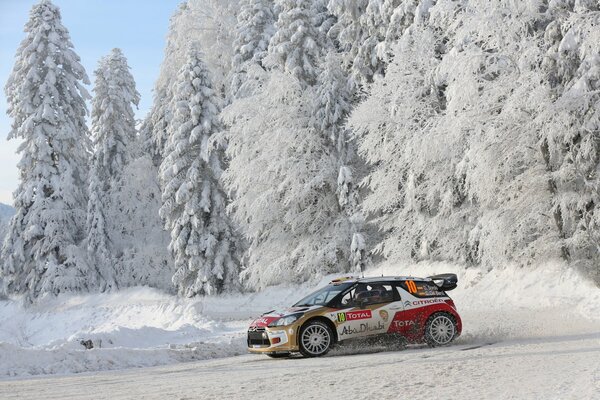 A car on a rally on a snowy highway