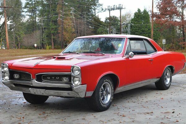 Classic red Pontiac on a country road