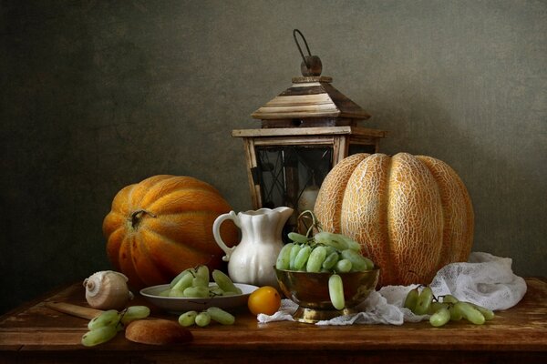 Still life with pumpkins and grapes on the table