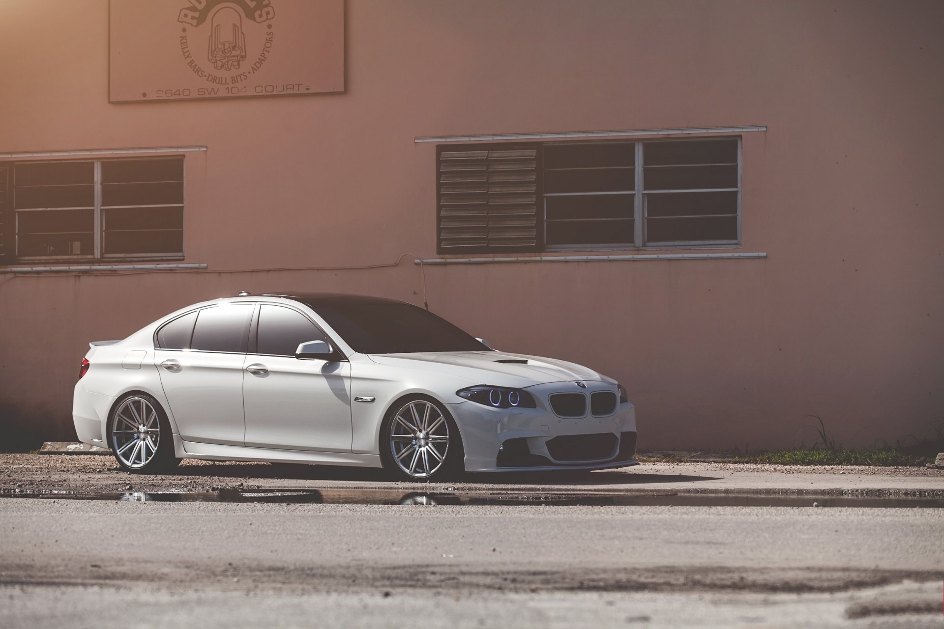 bmw 550i f10 white bmw front view building window