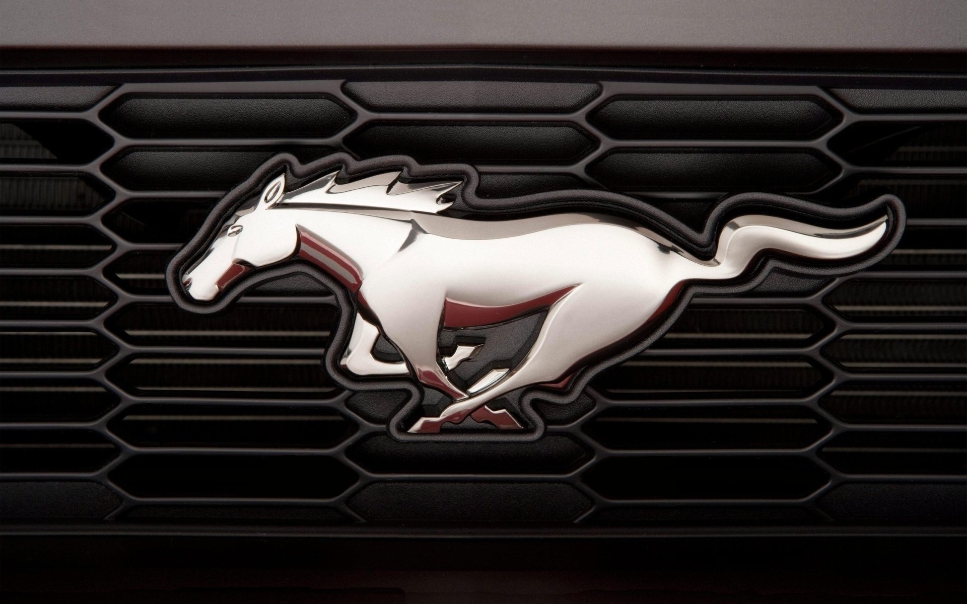 ford mustang emblem nameplate horse horse chrome radiator grille macro