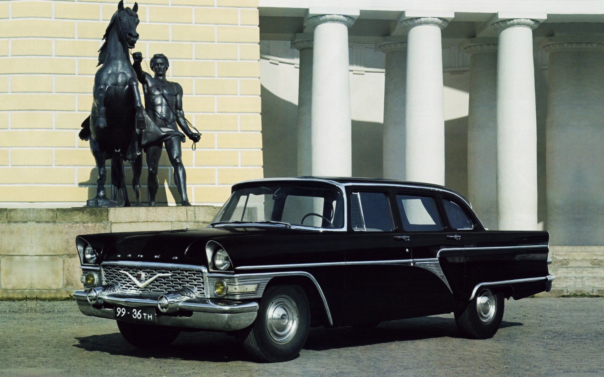 gaz chaika 1959 sedan front classic old woman columns background