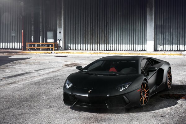 Black Lamborghini Aventador with orange discs