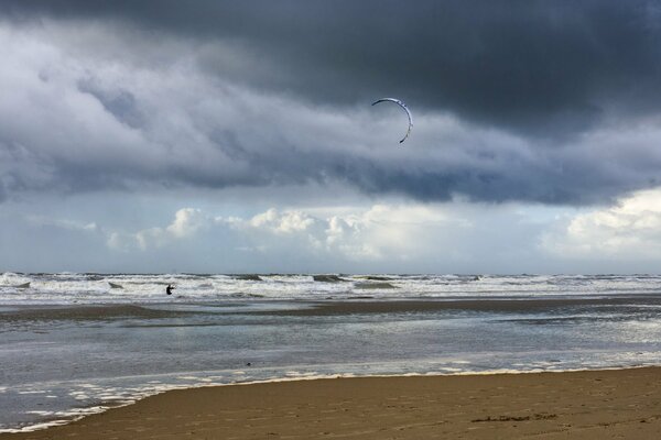 Low sky with gloomy clouds on the seashore with waves